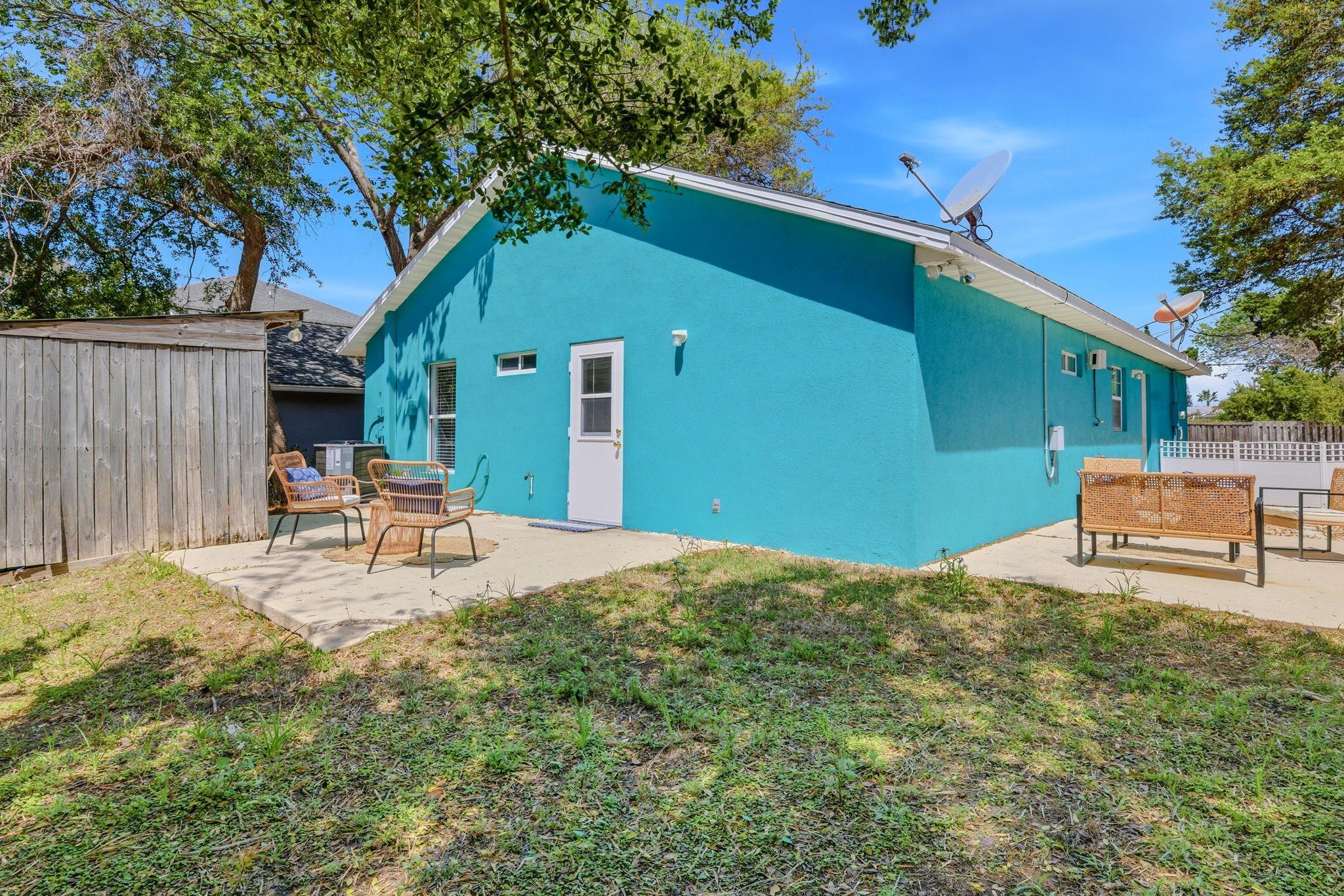 207 11th Street St. Augustine, FL 32080 - Photo 25 of 28 a backyard of a house with table and chairs
