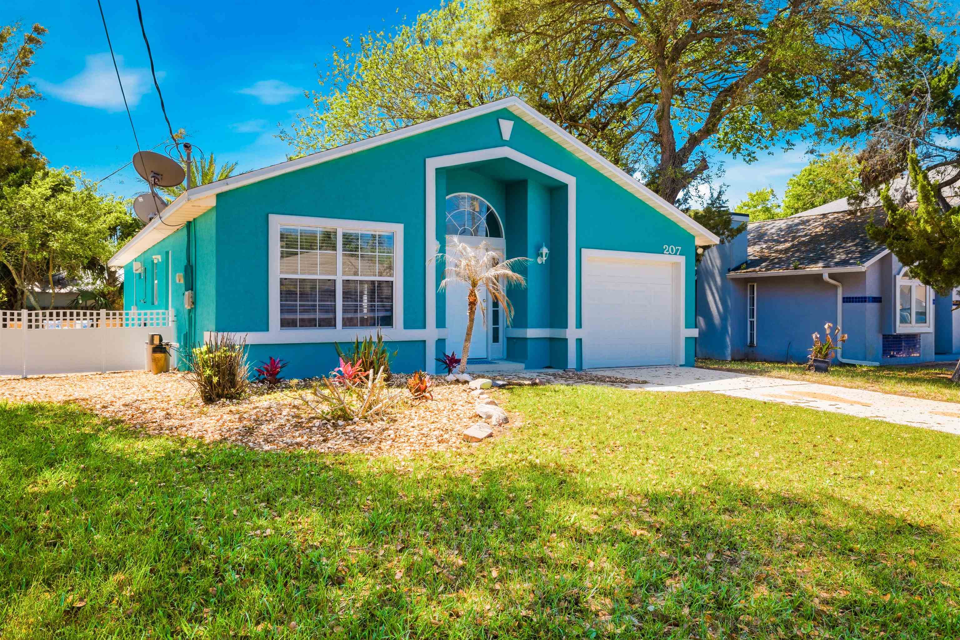 207 11th Street St. Augustine, FL 32080 - Photo 28 of 28 a front view of house with yard and trees in the background