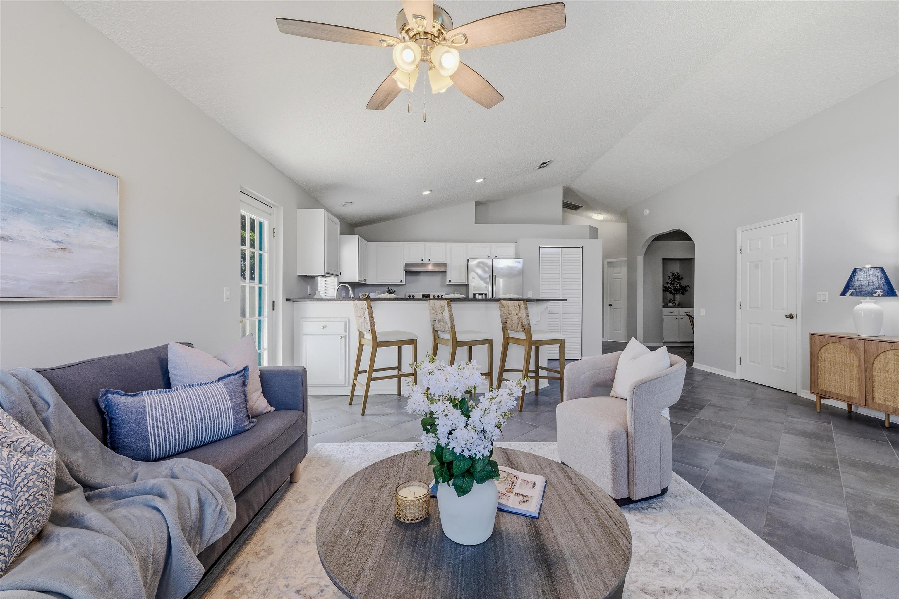 207 11th Street St. Augustine, FL 32080 - Photo 6 of 28 a living room with furniture and a chandelier