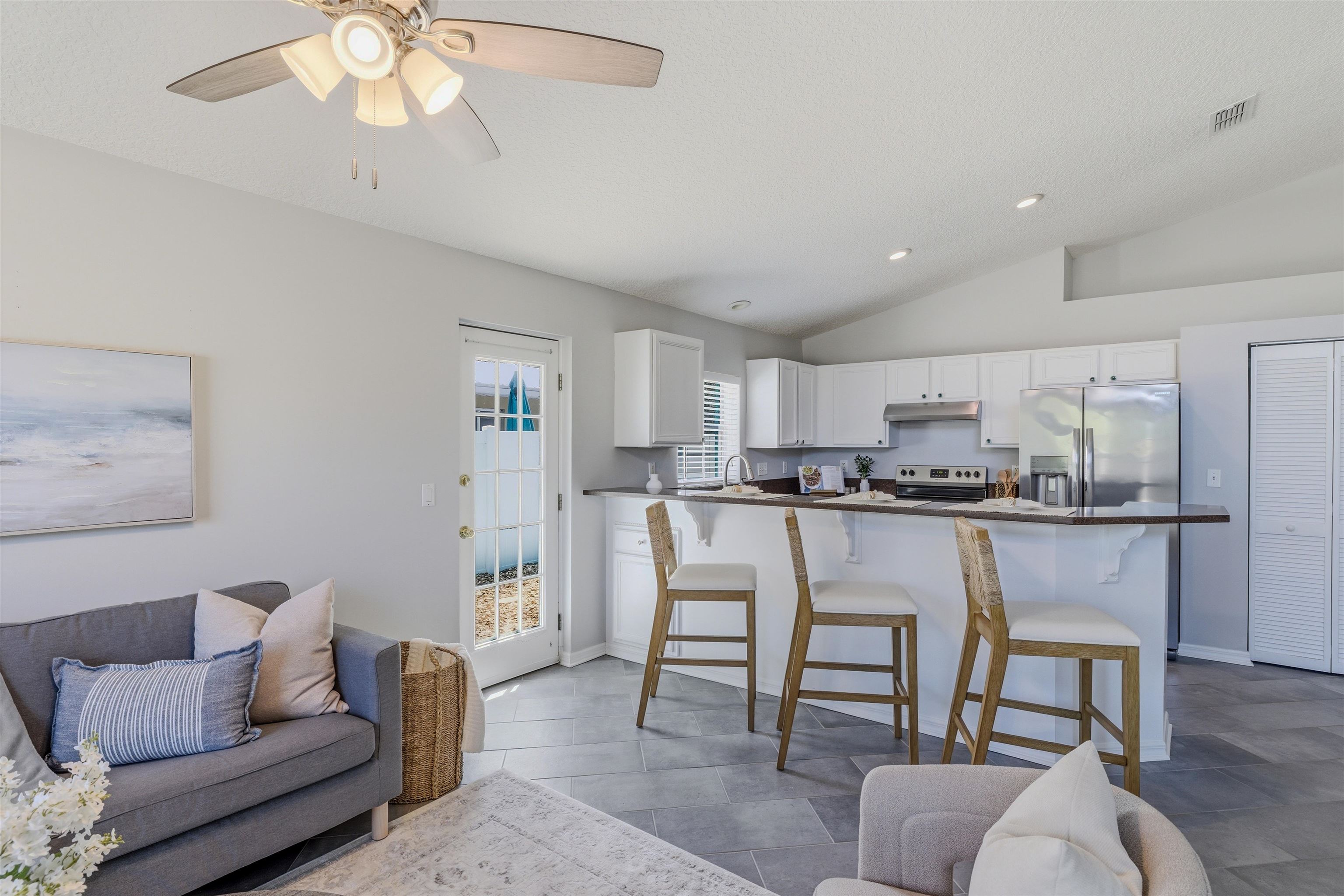 207 11th Street St. Augustine, FL 32080 - Photo 8 of 28 a living room with stainless steel appliances furniture and a kitchen view