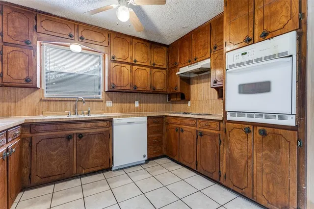 a kitchen with stainless steel appliances granite countertop a sink and cabinets