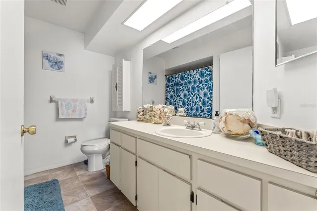 a view of a hallway with closet and a window