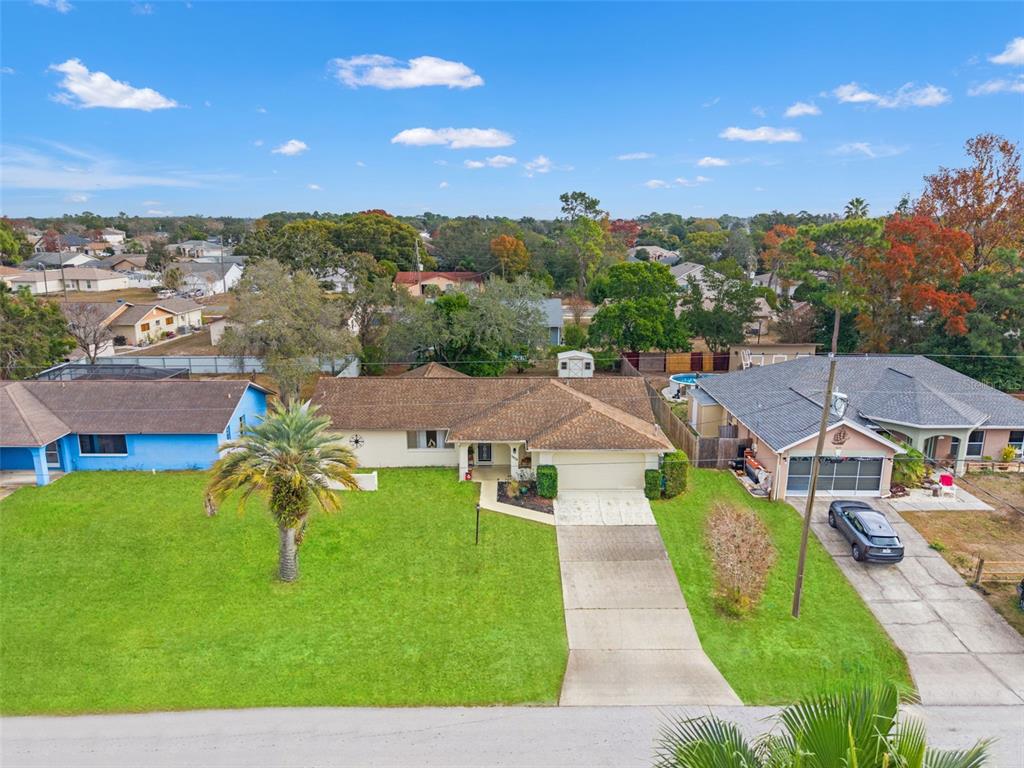 5078 Kenmore Street Spring Hill, FL 34608 - Photo 2 of 31 an aerial view of a house with a garden