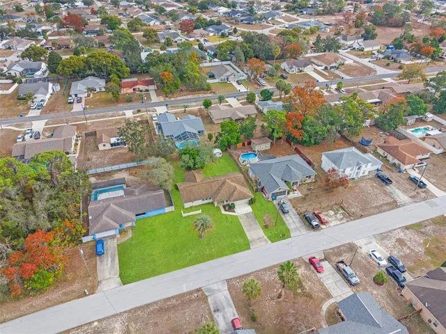an aerial view of residential houses with outdoor space
