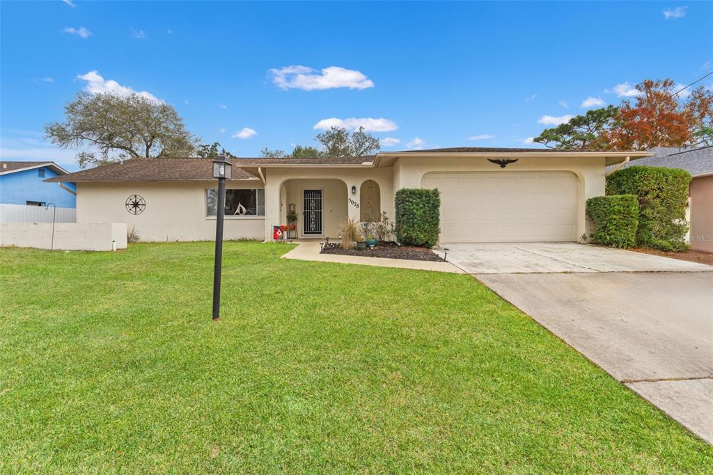 5078 Kenmore Street Spring Hill, FL 34608 - Photo 4 of 31 front view of a house with a yard