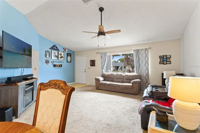 a dining room with furniture potted plants and wooden floor