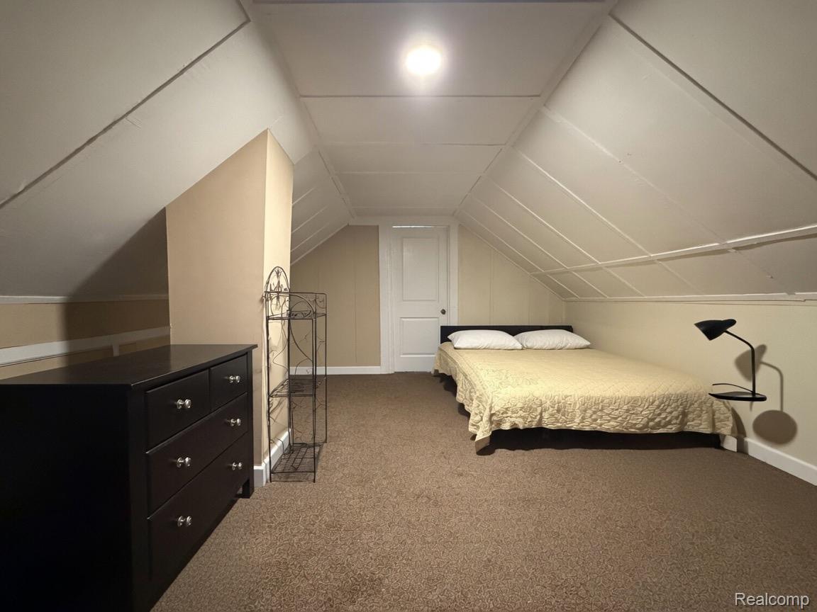 9940 Manor Detroit, MI 48204 - Photo 10 of 16 Attic room featuring sloped ceilings, a light beige wall color, white trim, and brown carpet flooring