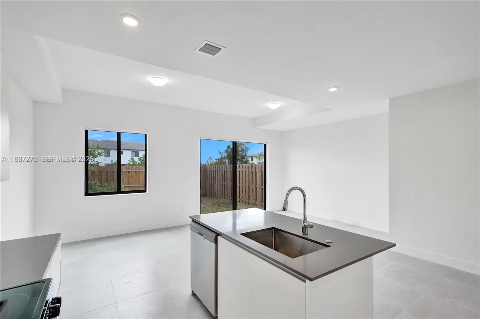 18944 Southwest 344th Terrace Homestead, FL 33034 - Photo 9 of 58 a kitchen with a sink and a large mirror
