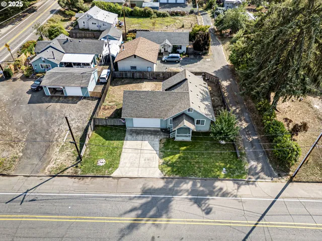 an aerial view of a house with a yard