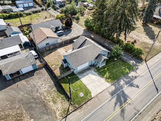 an aerial view of a house with garden space and street view