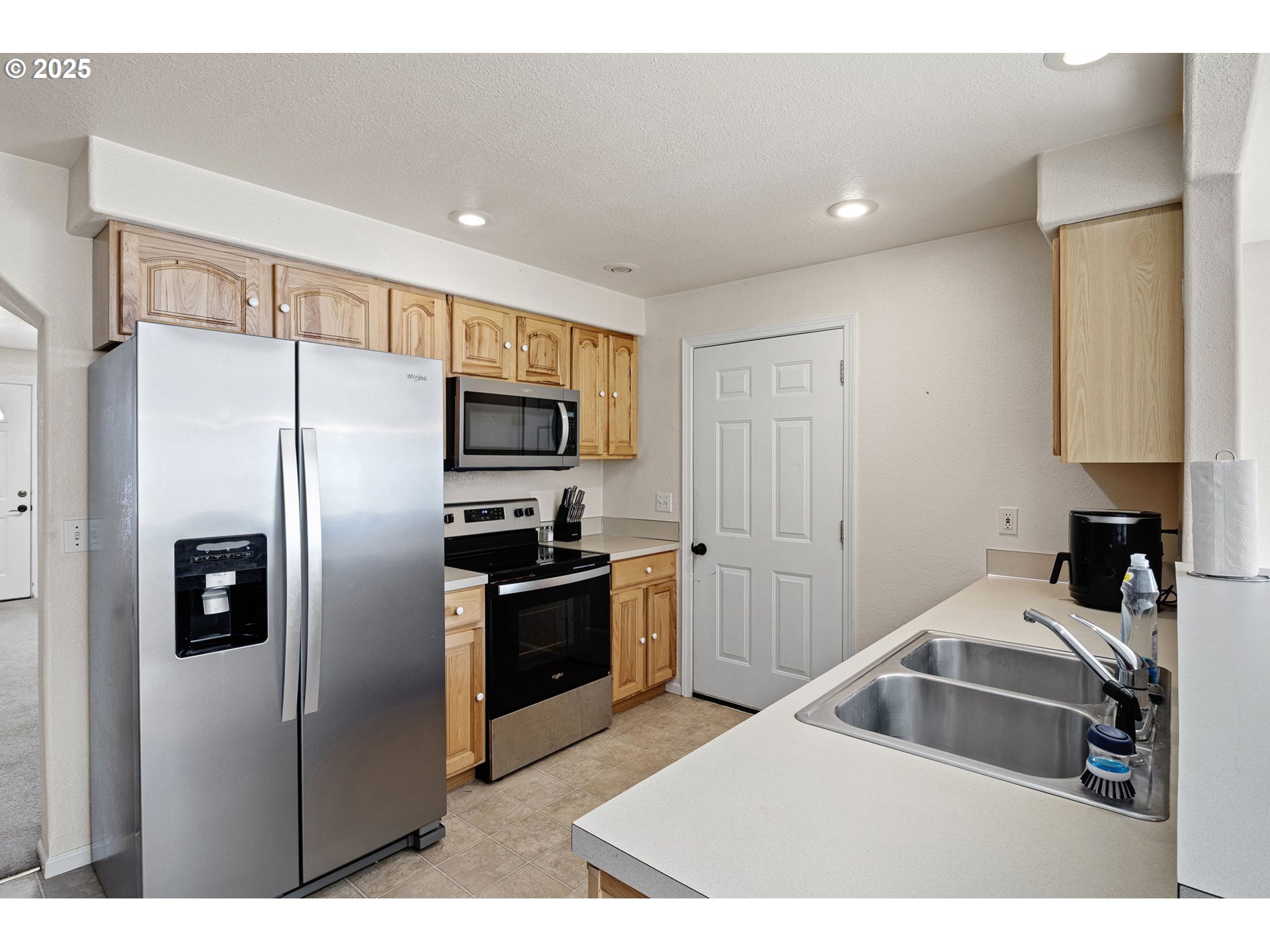 405 Lane Avenue Drain, OR 97435 - Photo 21 of 47 a kitchen with stainless steel appliances granite countertop a refrigerator and a sink