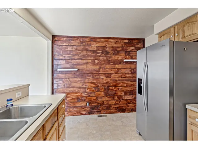 a kitchen with stainless steel appliances a refrigerator and a stove