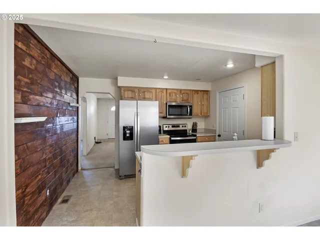 a workspace with wooden floor windows and a chandelier