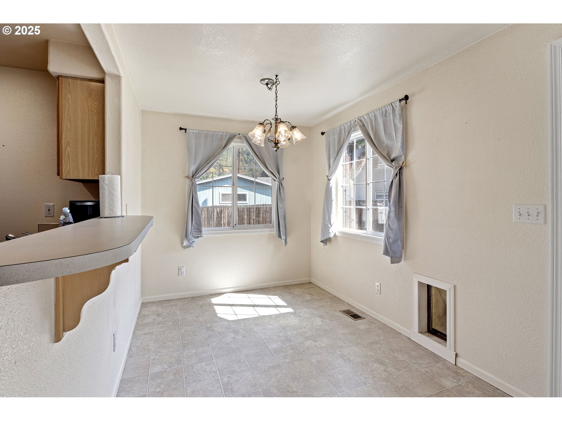405 Lane Avenue Drain, OR 97435 - Photo 27 of 47 a workspace with wooden floor windows and a chandelier