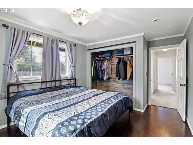 a bedroom with a bed next to a window