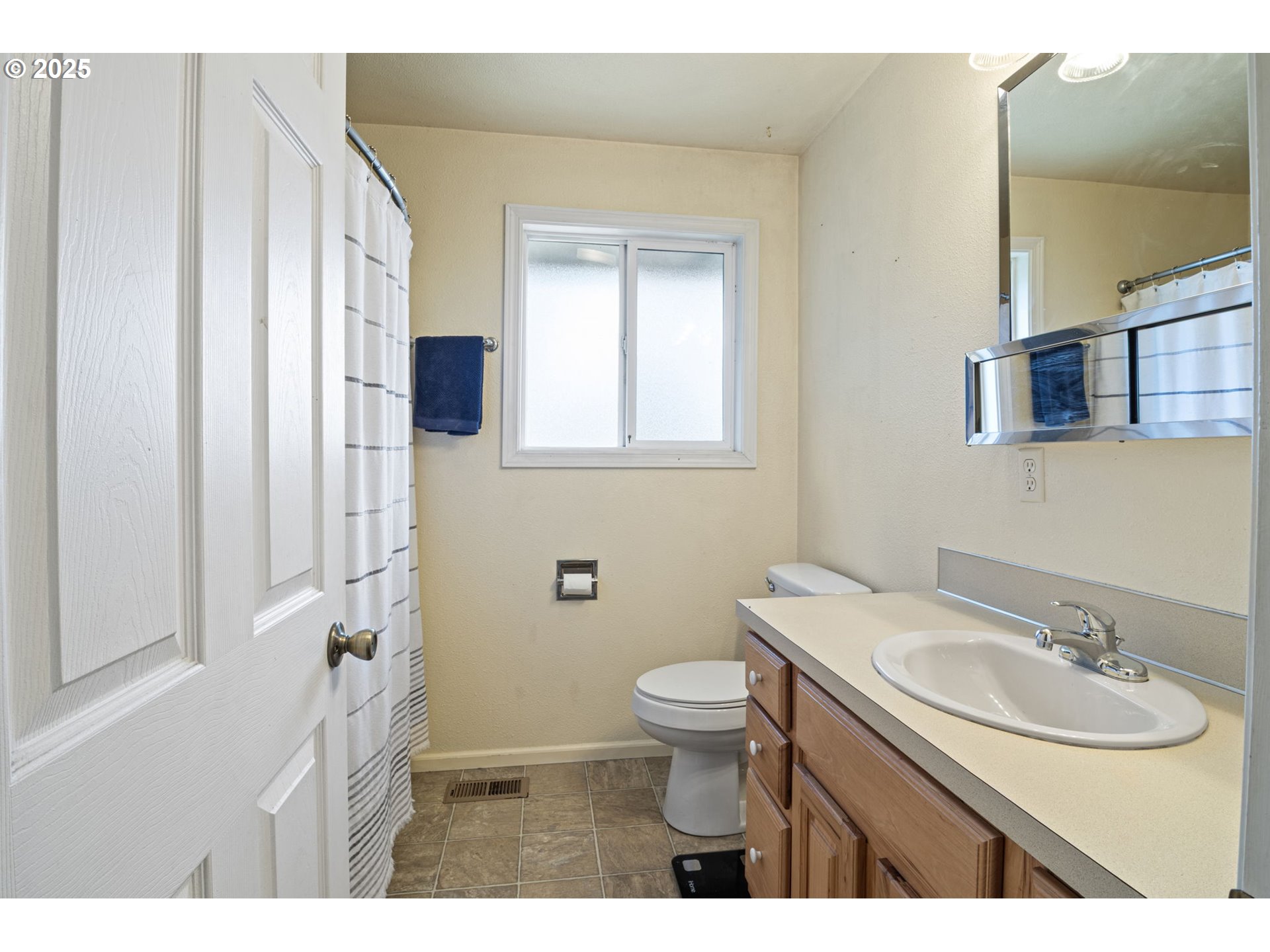 405 Lane Avenue Drain, OR 97435 - Photo 38 of 47 a bathroom with a sink a toilet and a mirror