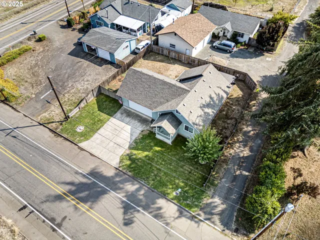 an aerial view of a house with garden space and street view