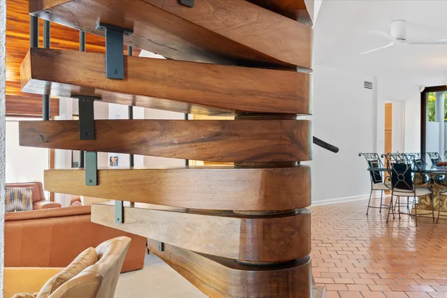 a view of an empty room with furniture and a window