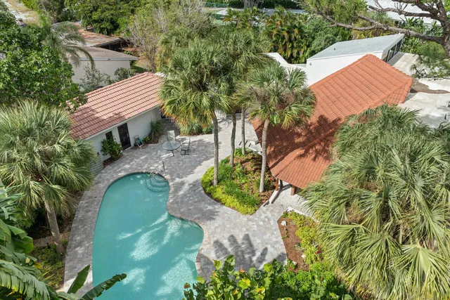 an aerial view of a house with a yard and trees