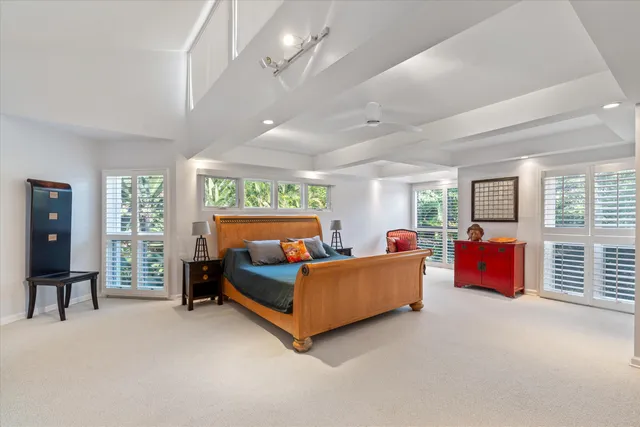 a bedroom with furniture and a large window