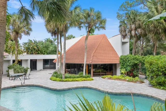 a front view of a house with garden and patio
