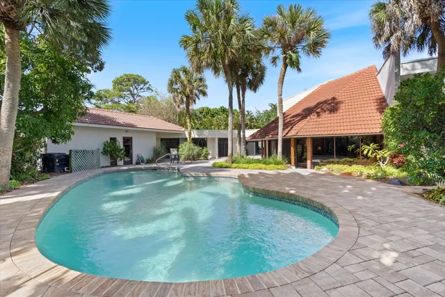 a view of a patio with table and chairs and potted plants