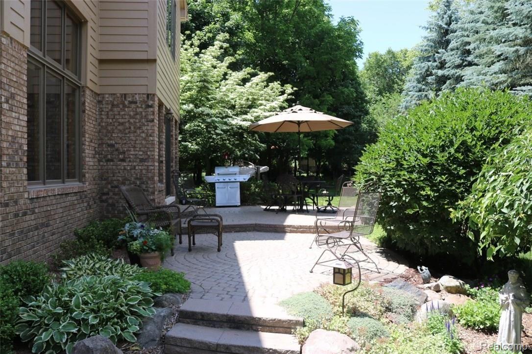 THE BRICK PAVER RAISED PATIO EXTENDS FROM THE BREAKFAST NOOK TO THE 2 STORY GREAT ROOM.