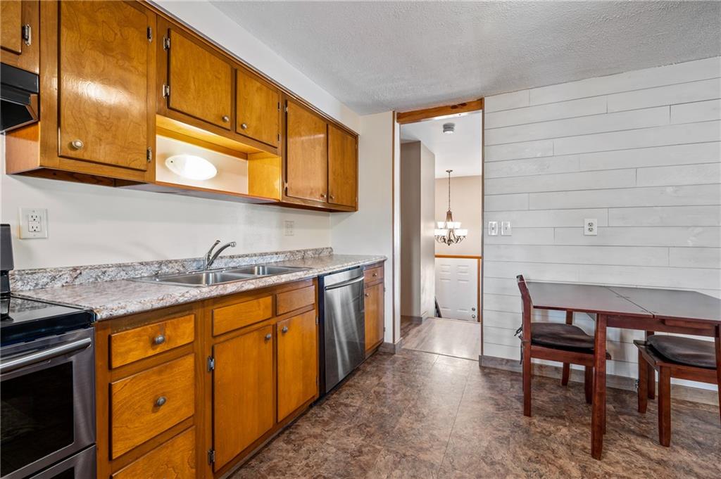 1885 George Circle Irwin, PA 15642 - Photo 11 of 25 a kitchen with stainless steel appliances granite countertop a sink and cabinets