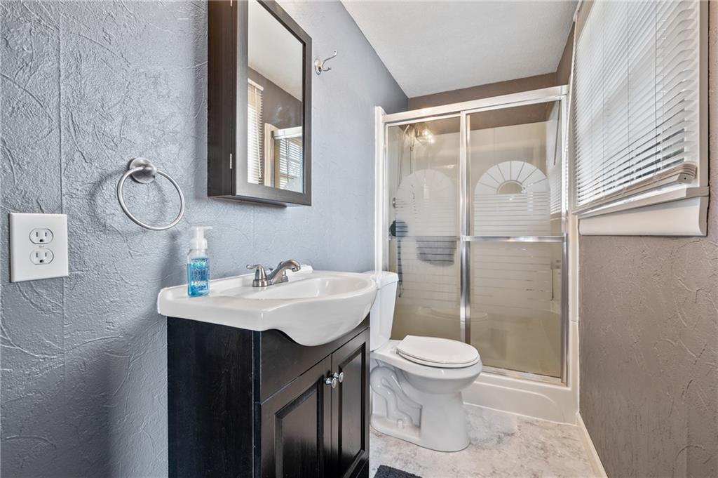 1885 George Circle Irwin, PA 15642 - Photo 14 of 25 a bathroom with a sink toilet and shower