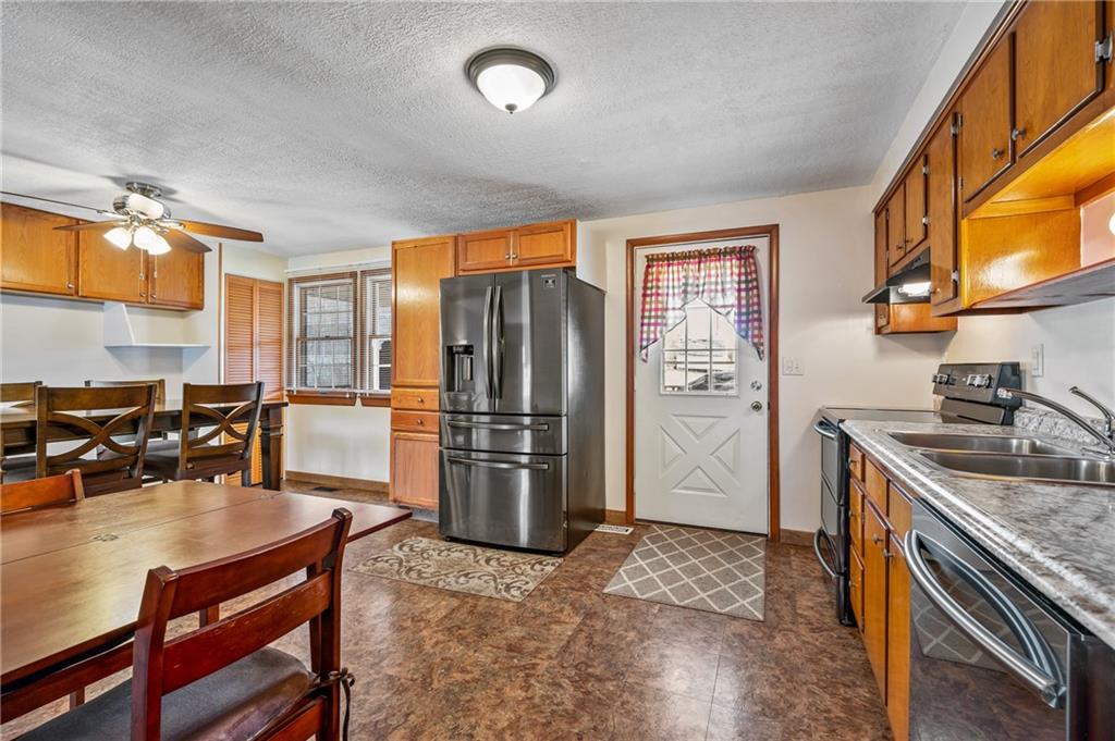 1885 George Circle Irwin, PA 15642 - Photo 8 of 25 a kitchen with stainless steel appliances granite countertop a refrigerator a stove and a sink with cabinets