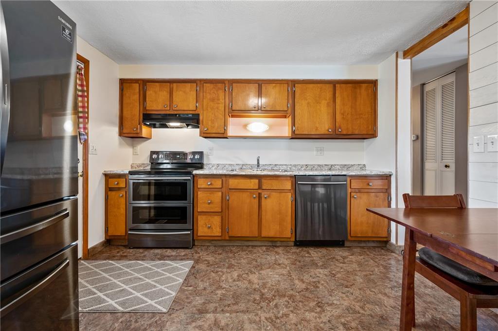 1885 George Circle Irwin, PA 15642 - Photo 10 of 25 a kitchen with stainless steel appliances granite countertop a stove and a refrigerator