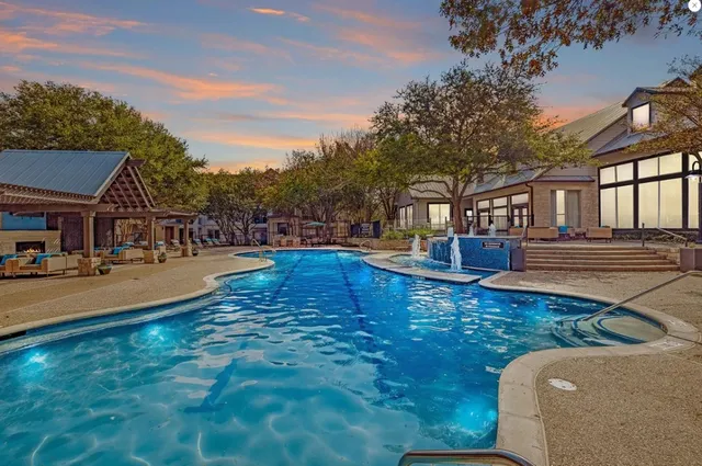 a swimming pool view with a outdoor seating