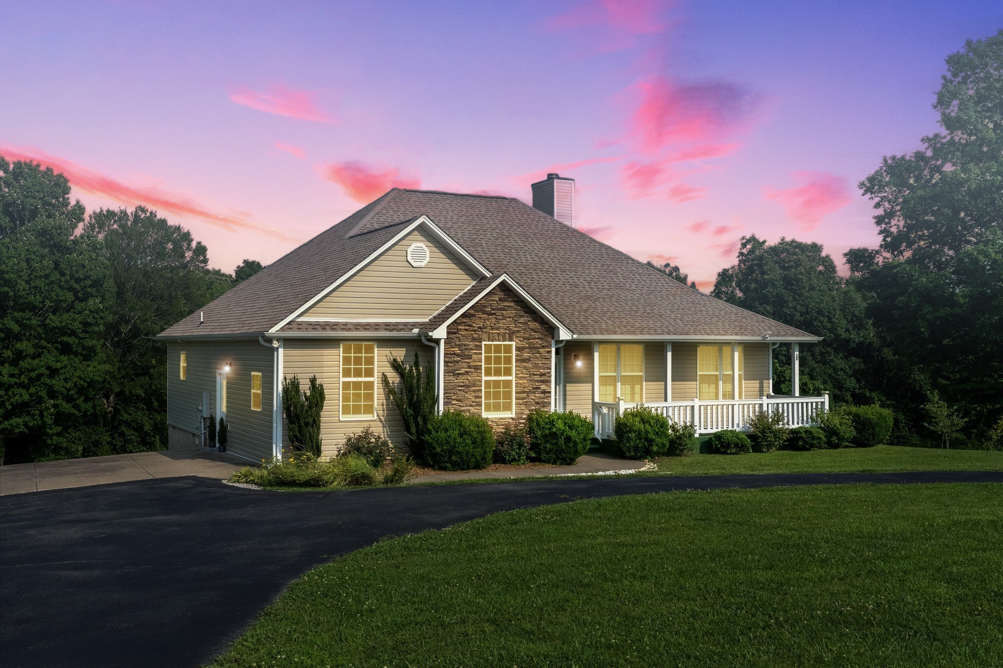 a front view of a house with a garden
