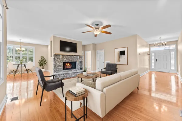 a living room with furniture a flat screen tv and a fireplace