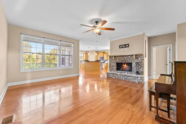 wooden floor fireplace and windows in an empty room