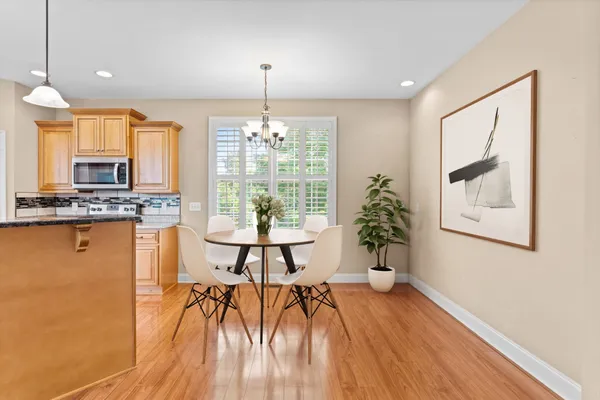 a very nice looking living room with a large window and wooden floor