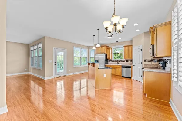 a view of a kitchen and dining room with wooden floor