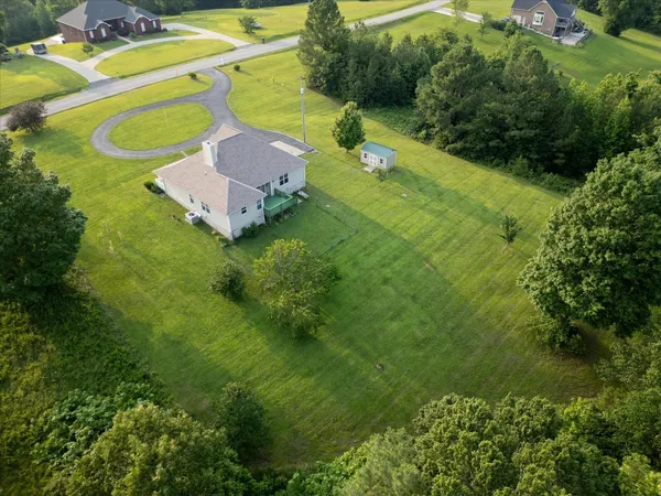 an aerial view of a house with a swimming pool