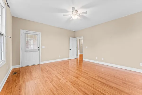 wooden floor in an empty room with a window