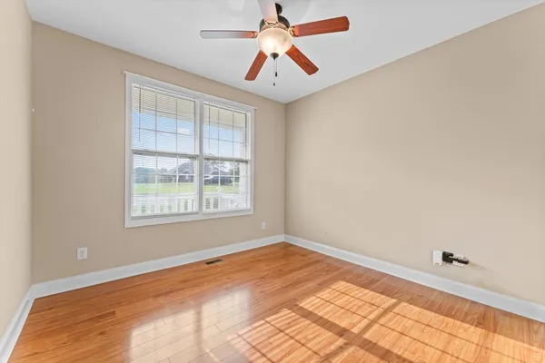 a view of room with window and ceiling fan