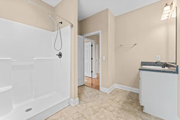 a bathroom with a shower and a sink