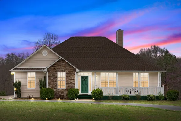 a front view of a house with a garden