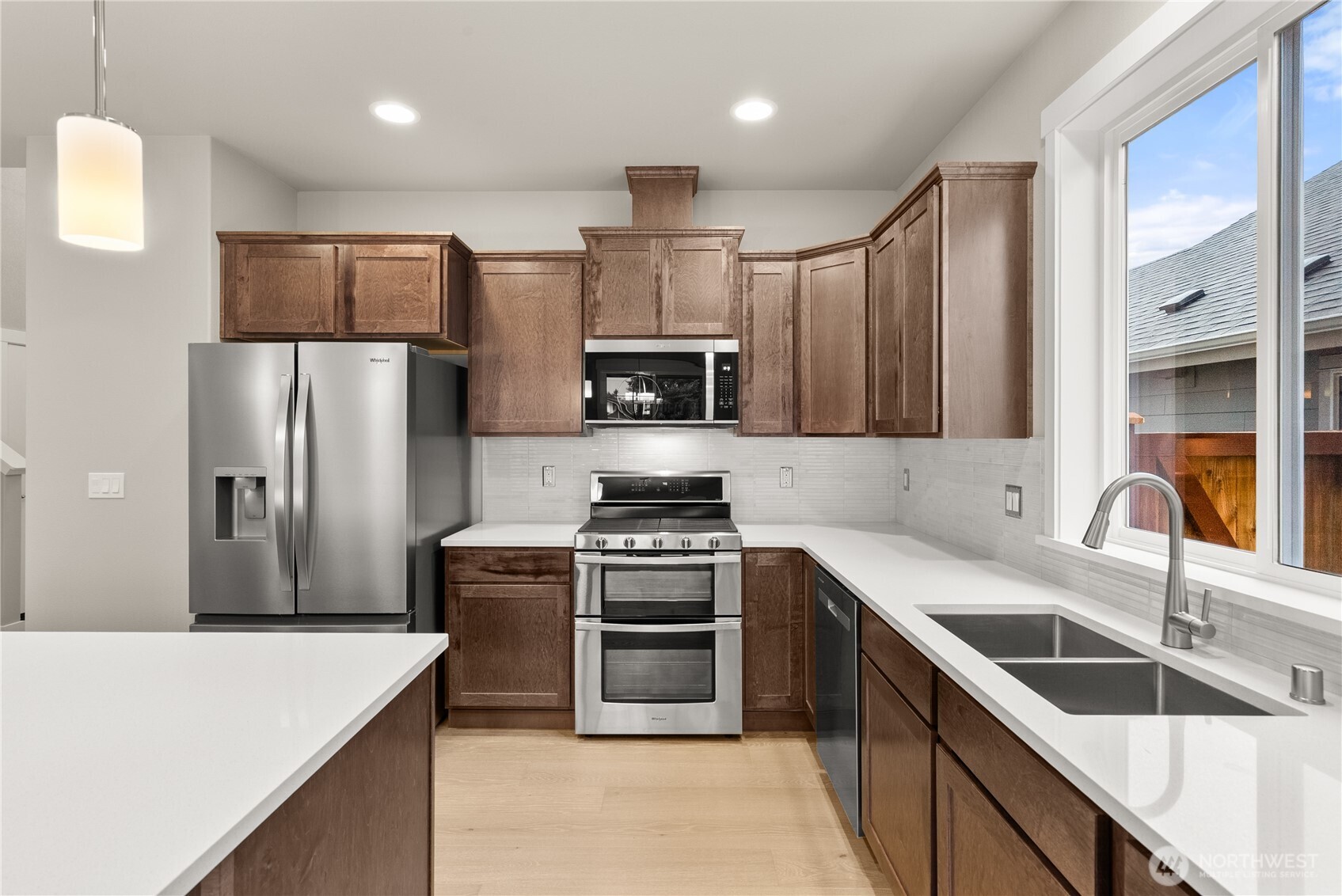 715 Maggee Street Southeast Lacey, WA 98513 - Photo 11 of 35 a kitchen with granite countertop a sink stove and refrigerator