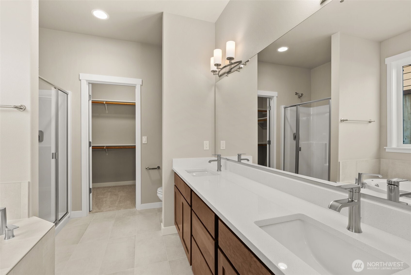 715 Maggee Street Southeast Lacey, WA 98513 - Photo 15 of 35 a bathroom with a double vanity sink a mirror and a shower