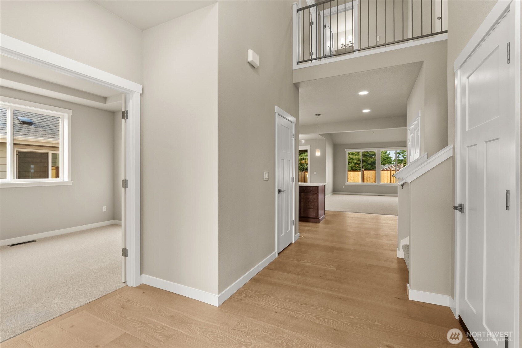 715 Maggee Street Southeast Lacey, WA 98513 - Photo 5 of 35 a view of a hallway with wooden floor and a kitchen