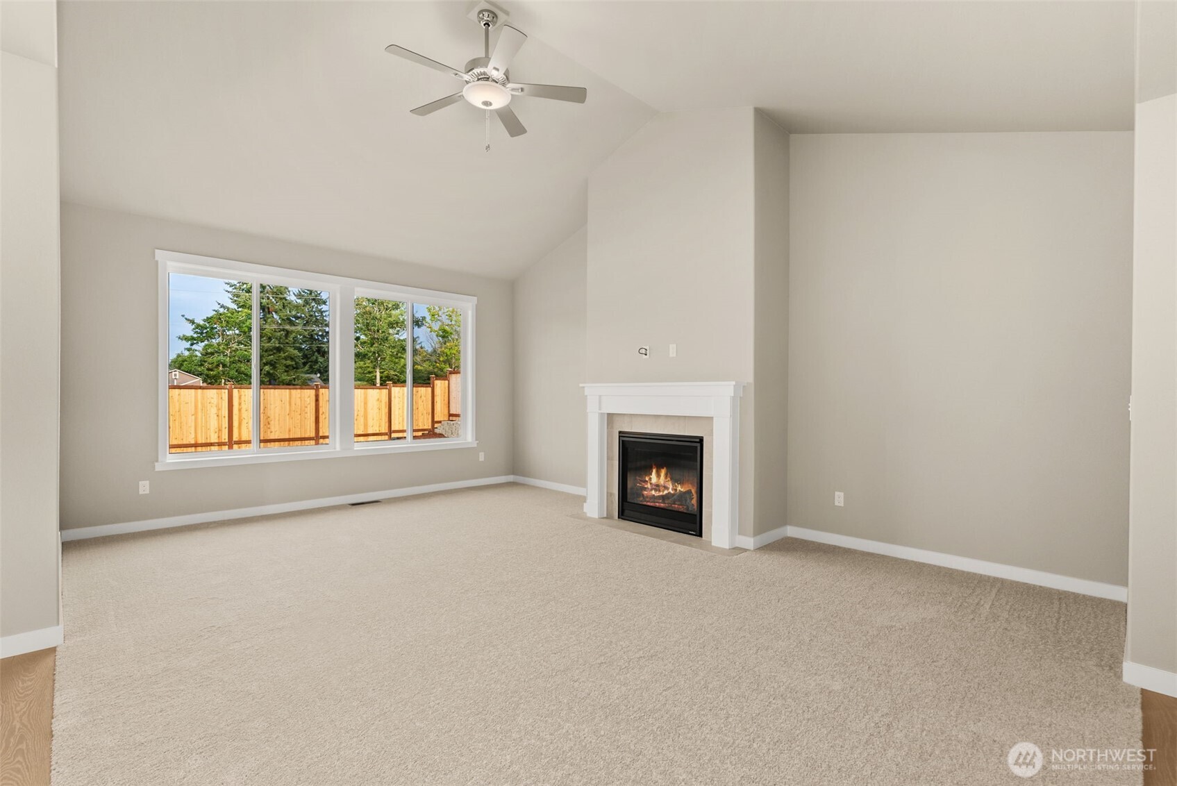 715 Maggee Street Southeast Lacey, WA 98513 - Photo 8 of 35 an empty room with windows fireplace and fan