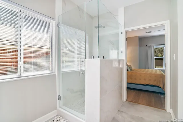 a en suite bathroom with a sink a mirror and a shower