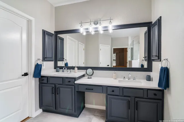 a bathroom with a sink and a mirror