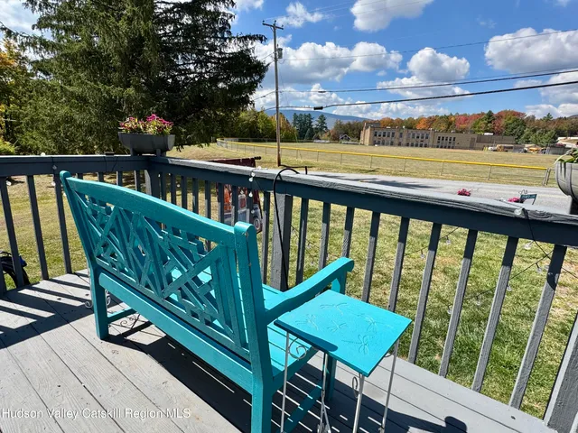 a view of a two chairs and table in the balcony