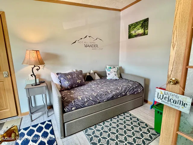 a bed sitting in a bedroom next to a couch